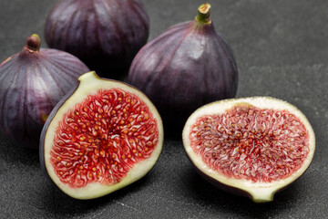 Two halves of fig and Whole purple figs.