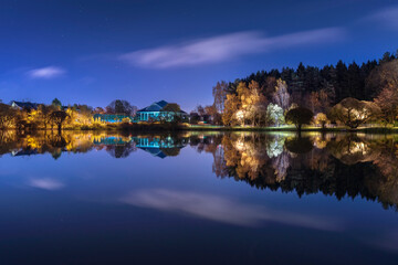 Moscow. October 15, 2021. Meshchersky Park and a pond in the moonlight. Autumn, night landscape with beautiful reflection