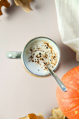 a cup of hot coffe with milk in autumn. autumn mood. autumn leaves.