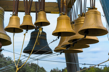 Church bells hanging in a wooden bell tower. church bellson a wooden beam
