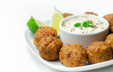Falafels, gently spiced blend of sweet potato, chickpeas and onion with a sour dip