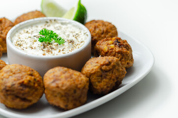 Falafels, gently spiced blend of sweet potato, chickpeas and onion with a sour dip