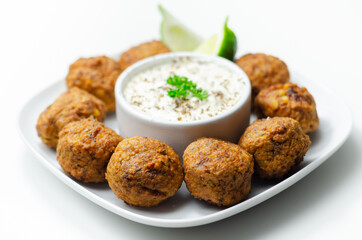 Falafels, gently spiced blend of sweet potato, chickpeas and onion with a sour dip
