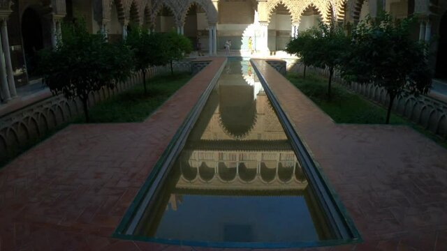 Seville, Spain, September 12, 2021: TILT SLOW - The Royal Palace of Seville (Real Alcazar). The Maidens Courtyard. The Mudejar of Pedro I on the ground floor and the Renaissance of the first monarchs.