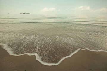 A tropical sea beach with a soft wave.