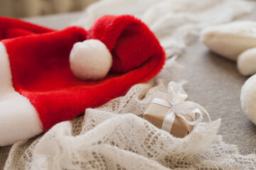 Fototapeta na wymiar christmas gift box and red santa hat for winter holidays
