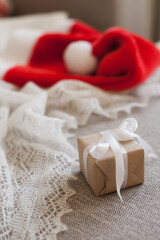 christmas gift box and red santa hat for winter holidays