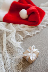 christmas gift box and red santa hat for winter holidays