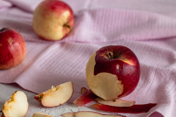 Delicious bitten red apple on a blurry background. Healthy eating.