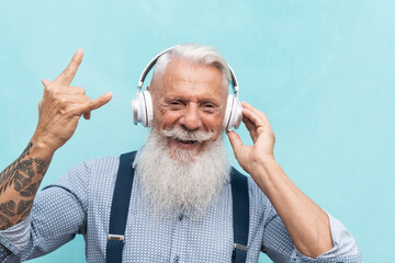 Senior hipster man listening rock playlist music with headphones - Elderly people enjoying...