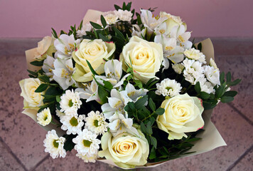 Beautiful bouquet in pastel colors on lilac background. Flowers for birthday, anniversary, wedding celebration. Close-up.