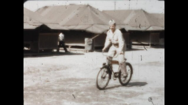 Hawthorne Deluxe Bicycle 1946. - A soldier rides a bicycle in camp.  