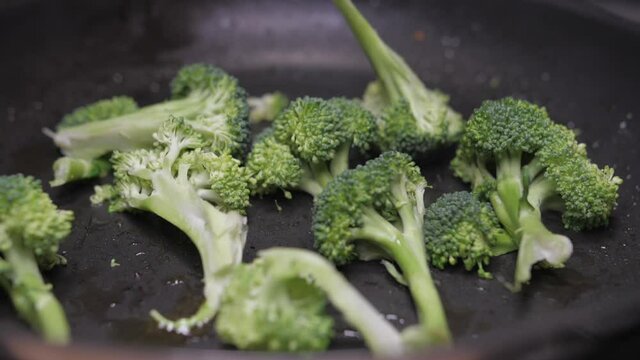 frying broccoli on oil fry pan slow motion