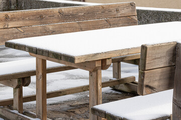 Fototapeta premium Wooden table with benches snowed in winter