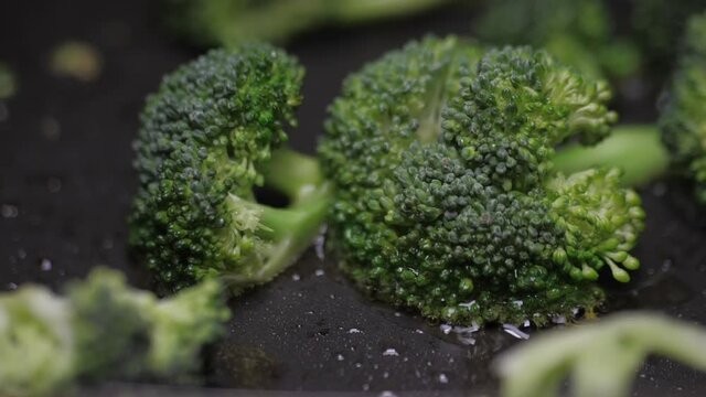 frying broccoli on oil fry pan slow motion