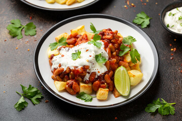 Spicy Bean Chilli with Baked Potato, sour cream and lime. Healthy Food