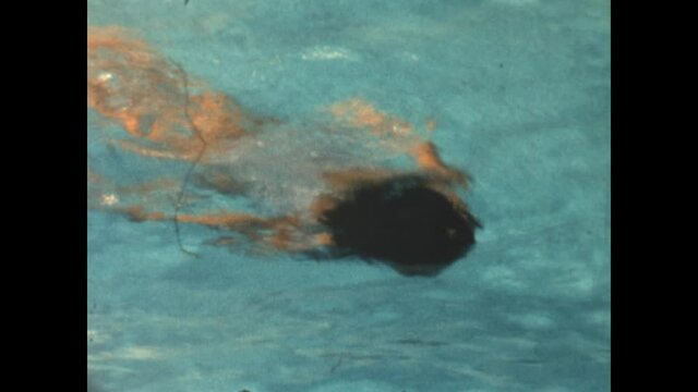Jump Into Pool 1965 - A girl jumps into a pool and swims across.  