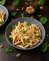 Whole Wheat Penne pasta with gorgonzola cheese sauce, spinach and walnut. Healthy food.