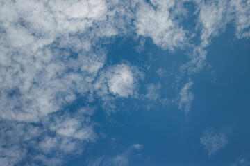 Altocumulus clouds with a clear blue sky background in the midday. Types of clouds stock images.