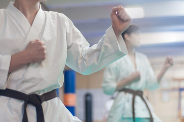 training on karate-do.  The karate fighter prepares to strike with his hand. Photo without faces. © Uladzimir