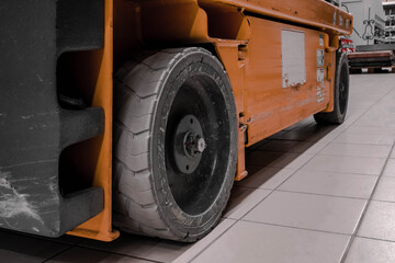 Photo of orange forklift wheels in a store