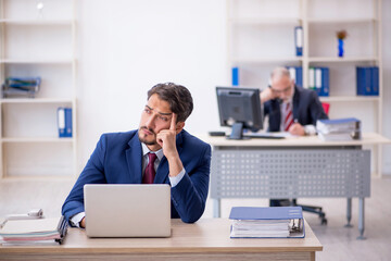Two male colleagues working in the office