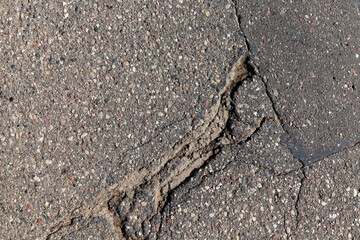 an asphalt road with a lot of holes and potholes