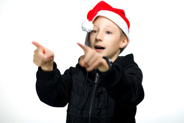 the boy in Santa's red hat shows the side with his hands