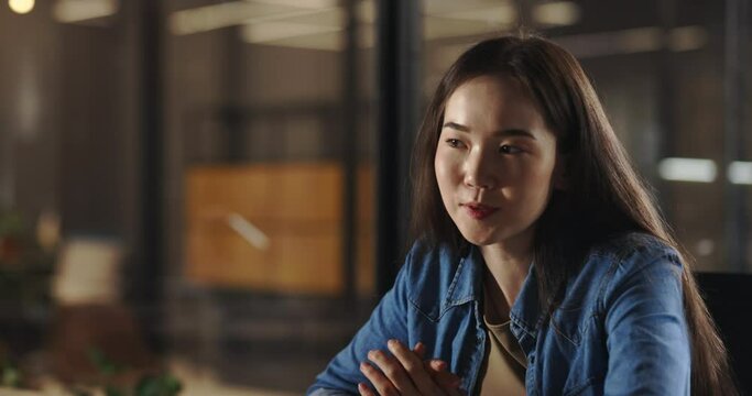 Positive young asian girl having a chat with friends or recording a vlog, cheerfully smiling and talking. Gen Z student having a job interview 4k footage