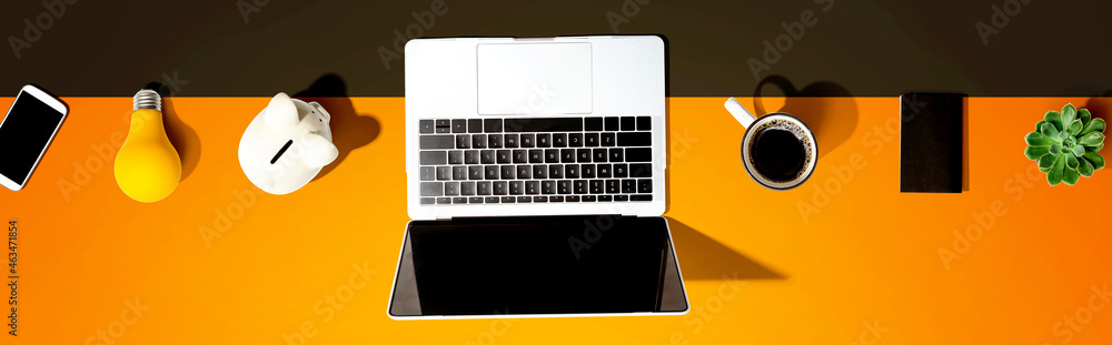 Poster laptop computer with a piggy bank and office objects