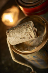 Old cans with paint and roller on a dark background