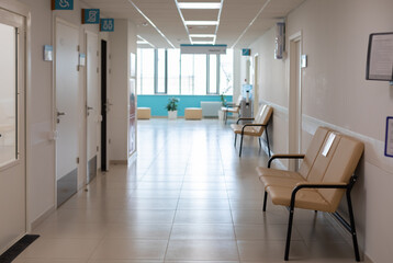 Empty corridor of hospitals, clinics, office rent. Sofas for seating and waiting area. Nobody