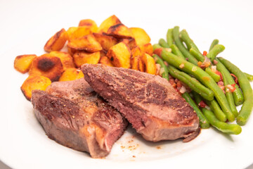 Medium cooked roast beef with potatoes with dark roast jus