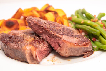 Medium cooked roast beef with potatoes with dark roast jus