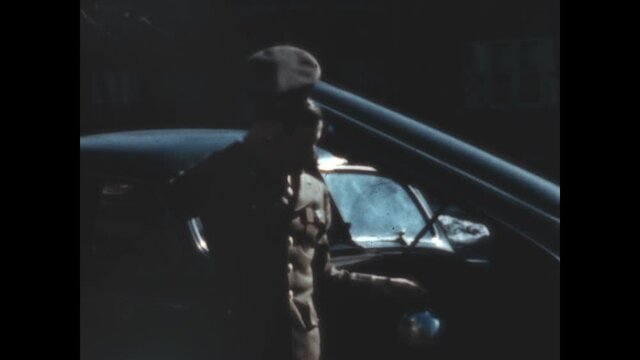Servicing Buick 1945 - A soldier checks under the hood of his Buick.  