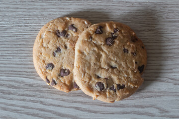 Two cookies on wooden background