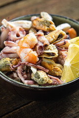 seafood fresh mix shrimp, squid, mussel, rapan, octopus portion ready to eat meal snack on the table copy space food background 