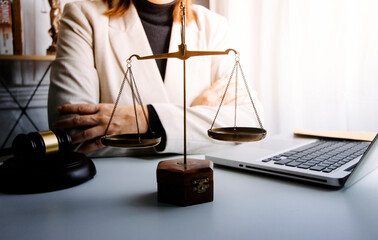 Business and lawyers discussing contract papers with brass scale on desk in office. Law, legal...