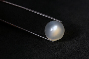 Genuine moonstone gemstone. Round shaped cabochon polished loose gemstone specimen. Semitransparent...