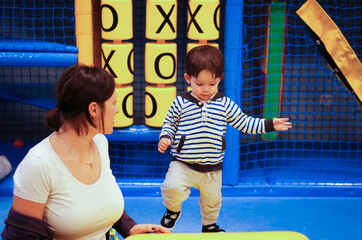 Young adorable Polish child playing  in the indoor playground