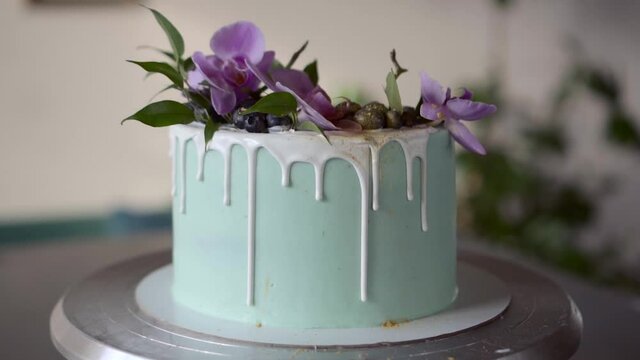 beautiful turquoise cake with blueberries and orchids, white chocolate