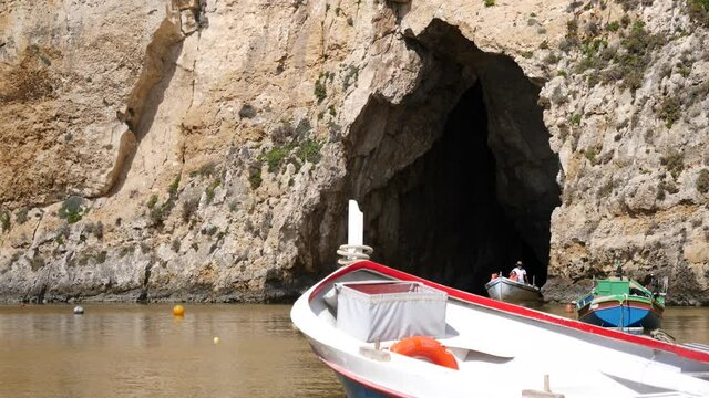 Boat with tourists come outside cave at Inland sea, Gozo