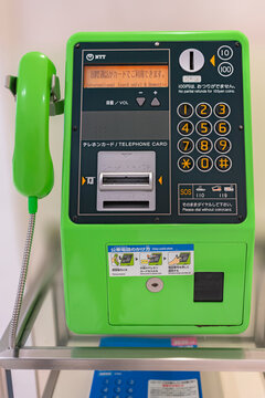 tokyo, japan - august 24 2021: Close up of a green NTT public telephone at a phone booth in department store maintain by Japanese government despite spread of cell phones as universal service system.