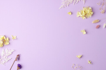 Cosmetic background with flowers on rose. Flat lay, copy space