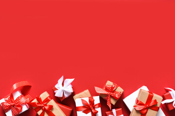 Boxes with ribbons on a red background.Present..Beautiful boxes with gifts. Shopping.