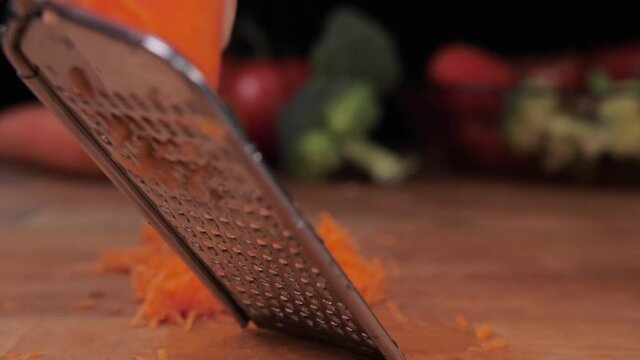 grate carrot on grater slow motion