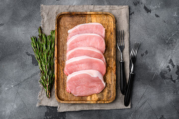 Fresh pork, on gray stone table background, top view flat lay, with copy space for text