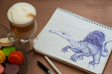 Still life with latte cup, macaroons and dino pen sketch i made while I was waiting for coffee 