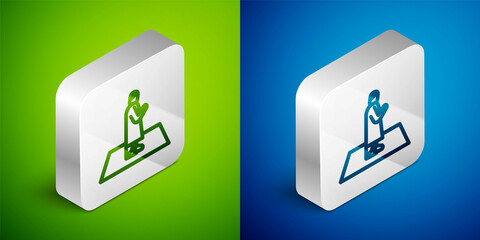 Isometric line Muslim man prays on the carpet icon isolated on green and blue background. Silver square button. Vector