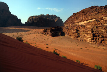 Fototapeta na wymiar Red sand and rocky mountains in Wadi Rum desert, Middle East, Jordan.
